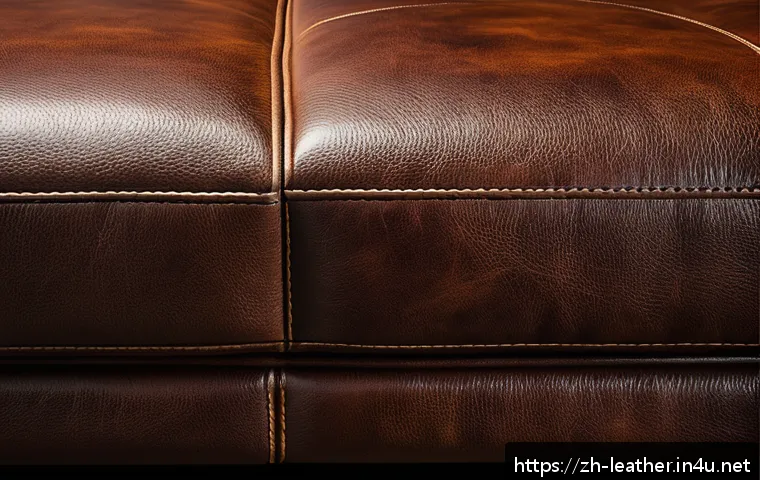 가죽공예 스크래치 처리 - A close-up view of a high-quality genuine leather sofa showing various types of scratches: shallow s...